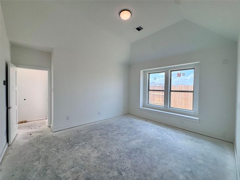 Even taller ceilings in the primary bedroom with over 13' vaulted ceilings and a build in bench for all that laundry we'll eventually fold.