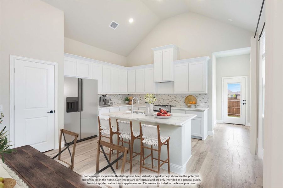 Kitchen with white cabinets, center island with seating, vaulted ceiling, and light wood floors