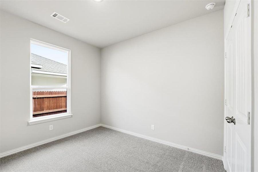 Empty room featuring baseboards and carpet floors