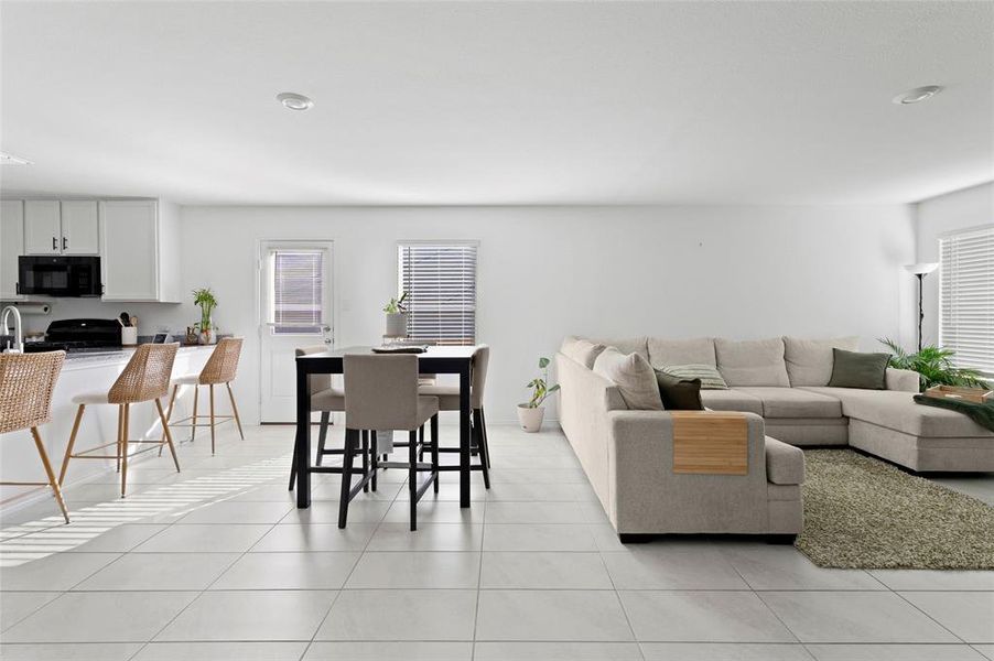 Living room with light tile patterned flooring
