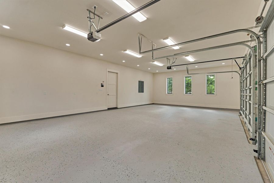 Built for the toys — an oversized 3-car garage with epoxy-coated floors, smart garage door openers, and a 32' back-out zone with 18' wide driveways. Plenty of room for trucks, trailers, and everything in between. Built for the toys — an oversized 3-car garage with epoxy-coated floors, smart garage door openers, and a 32' back-out zone with 18' wide driveways. Plenty of room for trucks, trailers, and everything in between.