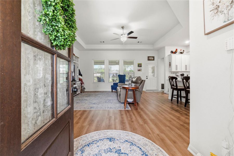Step inside and feel right at home in this warm, inviting living space, where farmhouse charm meets modern comfort with soaring ceilings, natural light, and an open layout made for gathering.