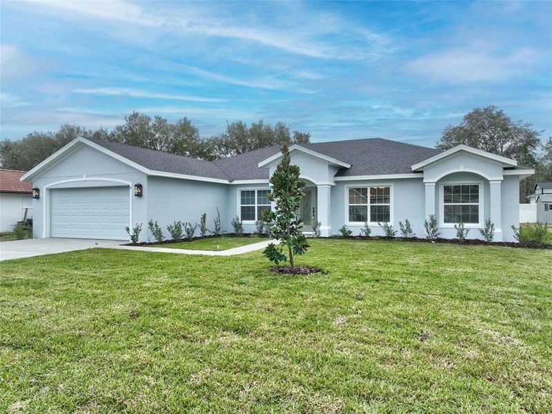 Front exterior of a new home in , Palm Coast, FL, highlighting curb appeal (Image 1).