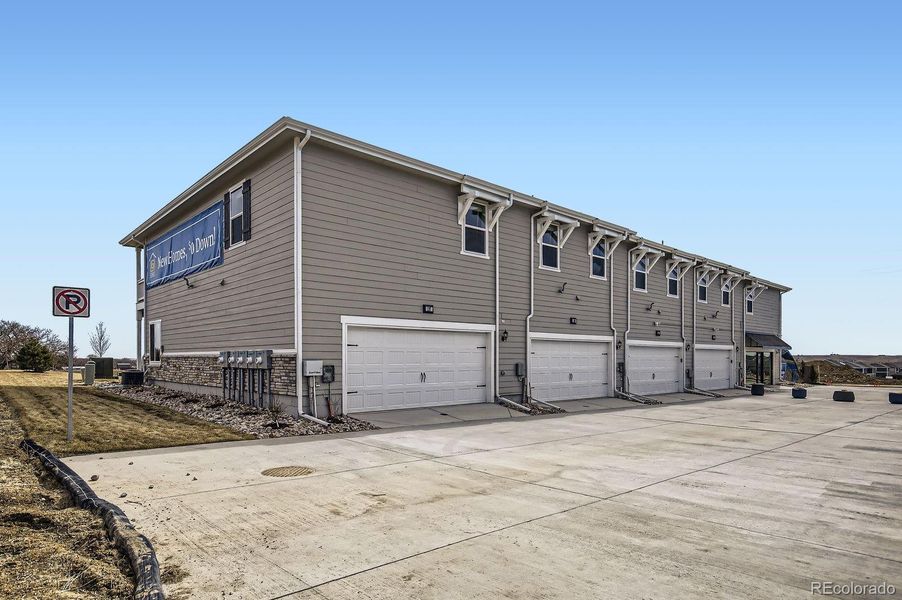 Front exterior of a new home in Johnstown Village, Johnstown, CO, highlighting curb appeal (Image 25).