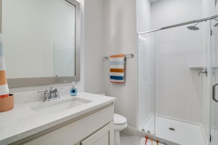 Bathroom with vanity, toilet, and a stall shower Bathroom with vanity, toilet, and a stall shower