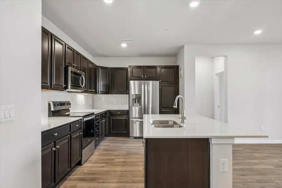 A kitchen with black cabinets.