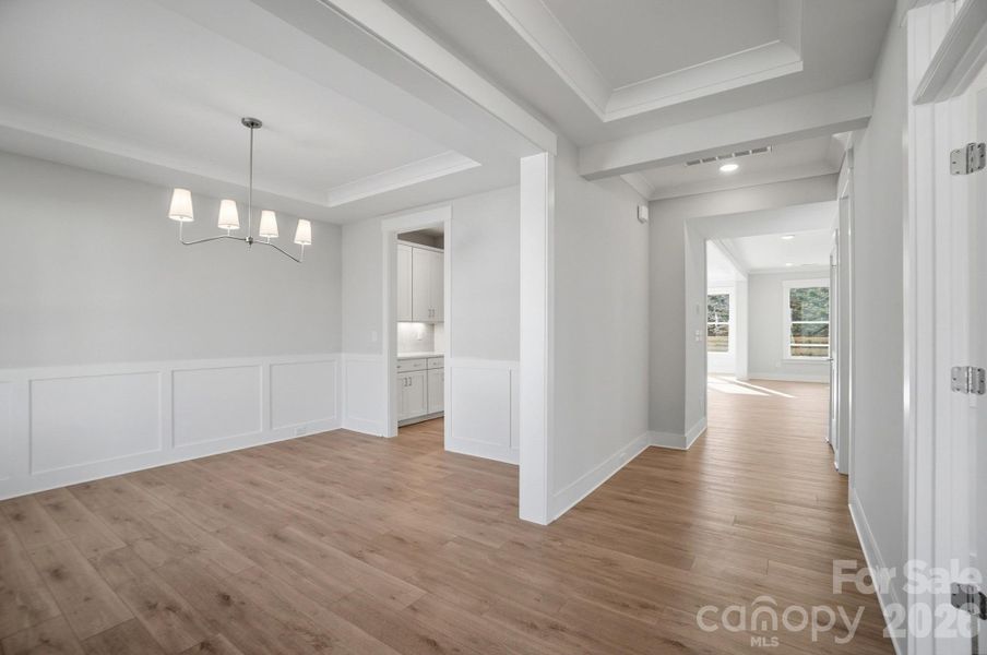 Dining room with Craftsman-style trim and tray ceiling