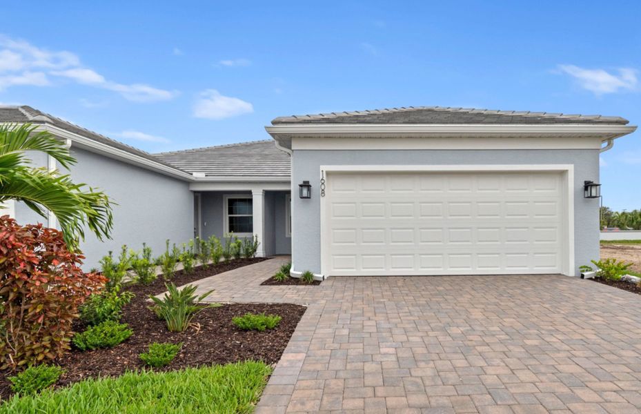 Front exterior of a new home in Shores at Stillwater, Englewood, FL, highlighting curb appeal (Image 2). Front exterior of a new home in Shores at Stillwater, Englewood, FL, highlighting curb appeal (Image 2).
