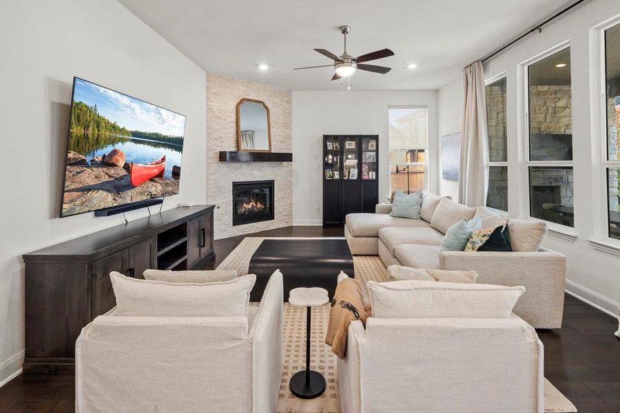 Living room with baseboards, dark wood-style flooring, and a fireplace