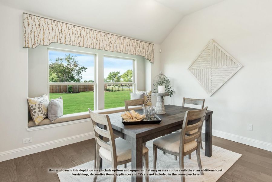 Dining area with dark wood table, four chairs, window seat, and large window overlooking backyard Dining area with dark wood table, four chairs, window seat, and large window overlooking backyard