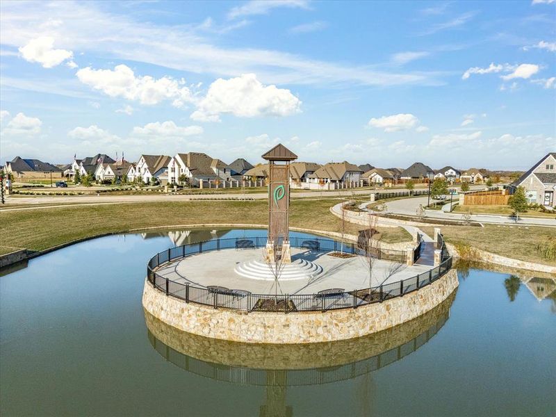 View of community featuring a yard, a residential view, a patio area, and a water view View of community featuring a yard, a residential view, a patio area, and a water view