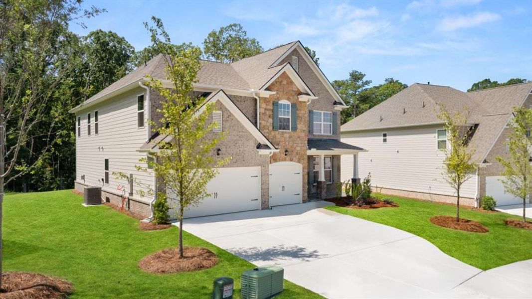 Front exterior of a new home in Holland Estates, Powder Springs, GA, highlighting curb appeal (Image 22). Front exterior of a new home in Holland Estates, Powder Springs, GA, highlighting curb appeal (Image 22).