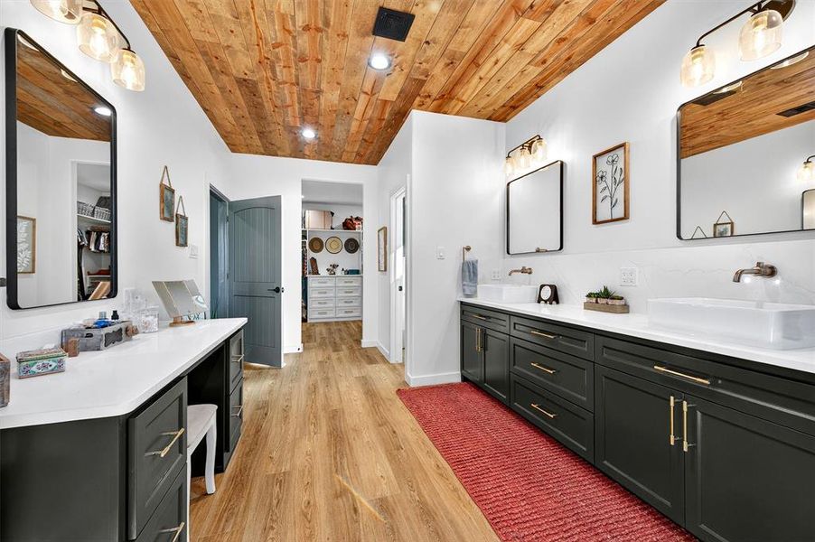 Bathroom featuring double vanity, light wood-style flooring, recessed lighting, and wood ceiling Bathroom featuring double vanity, light wood-style flooring, recessed lighting, and wood ceiling