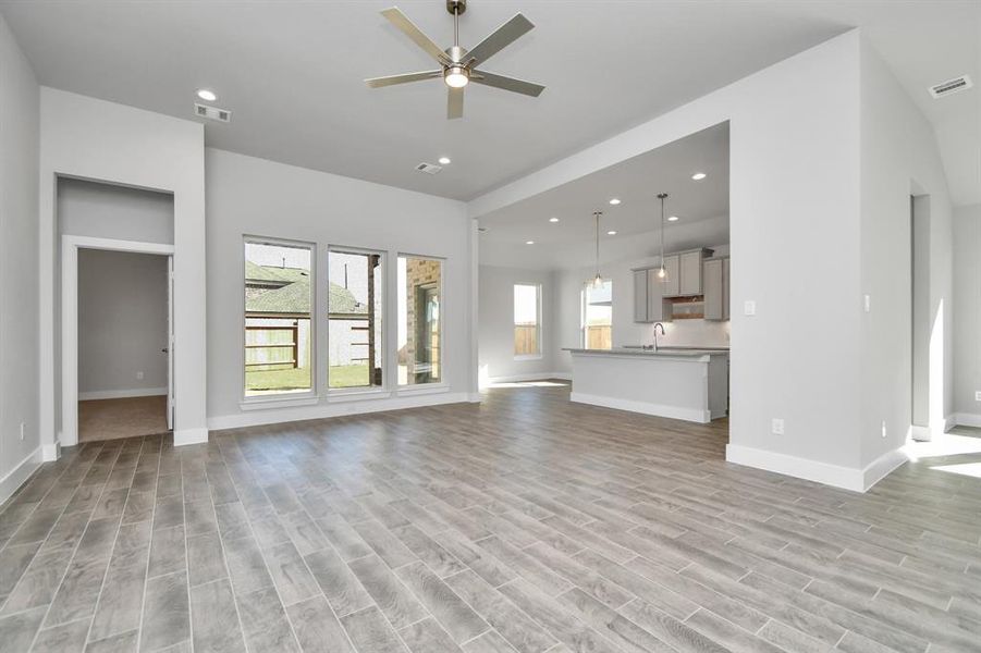 Take another glimpse into the heart of the home with this additional view of the family room—a sprawling space ready to accommodate all your gatherings. Sample photo of completed home with similar plan. As built color and selections will vary.