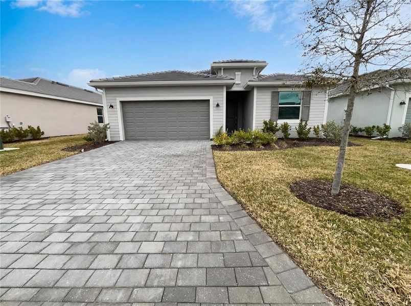 Front exterior of a new home in Harbor East, Port Charlotte, FL, highlighting curb appeal (Image 2).