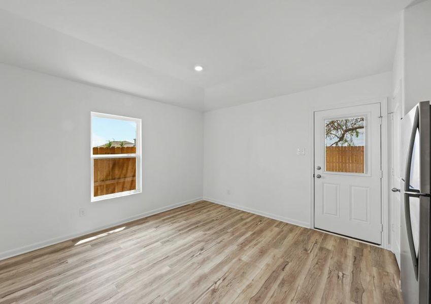 The dining area has a door that leads to the backyard