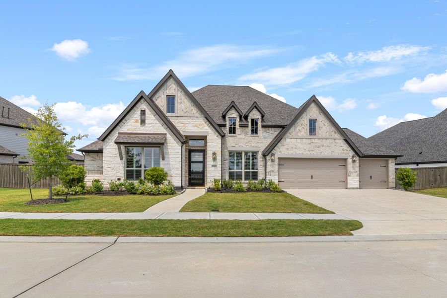 Front exterior of a new home in Riceland 70', Mont Belvieu, TX, highlighting curb appeal (Image 22).