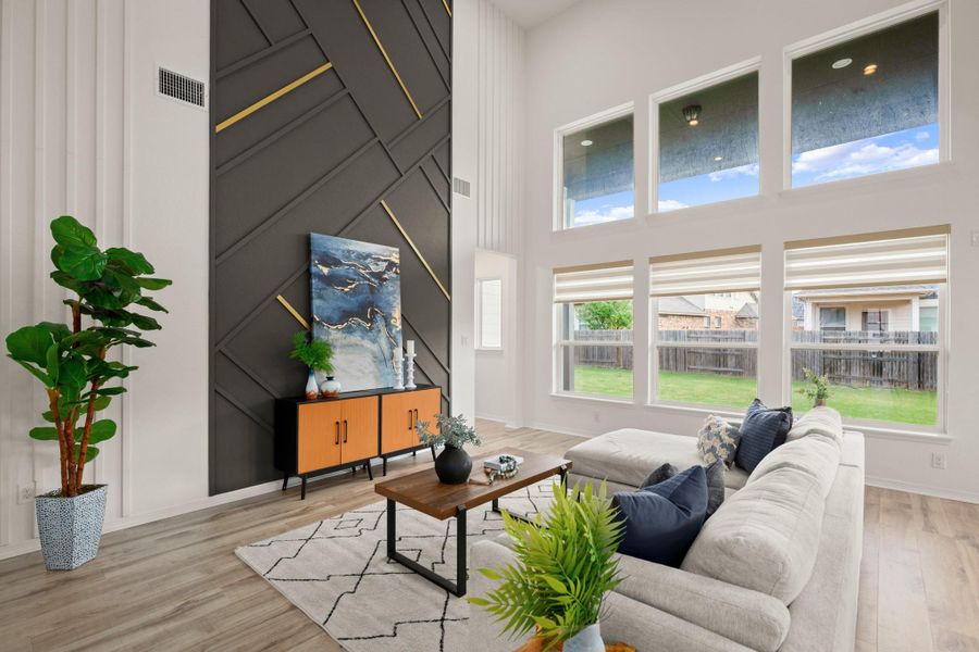 Luminous open floor plan living under soaring two-story ceilings with stacked windows and a showstopper accent wall. Luminous open floor plan living under soaring two-story ceilings with stacked windows and a showstopper accent wall.