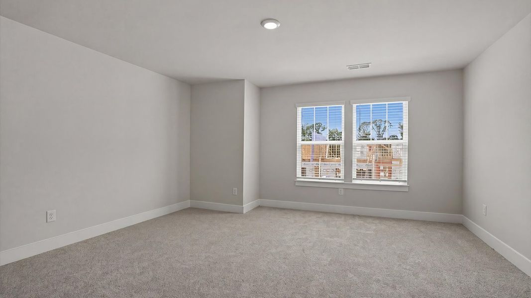 Accomplished design in this restful bedroom featuring plush carpet and oversized window views at Village at Midway Accomplished design in this restful bedroom featuring plush carpet and oversized window views at Village at Midway