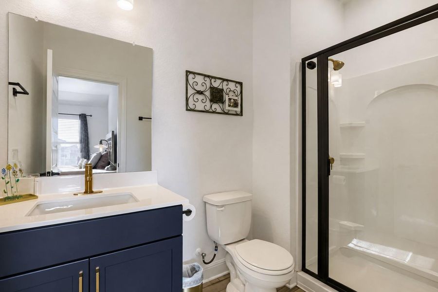 A well-appointed bathroom offers a vanity with ample counter space and a modern shower enclosure. A well-appointed bathroom offers a vanity with ample counter space and a modern shower enclosure.
