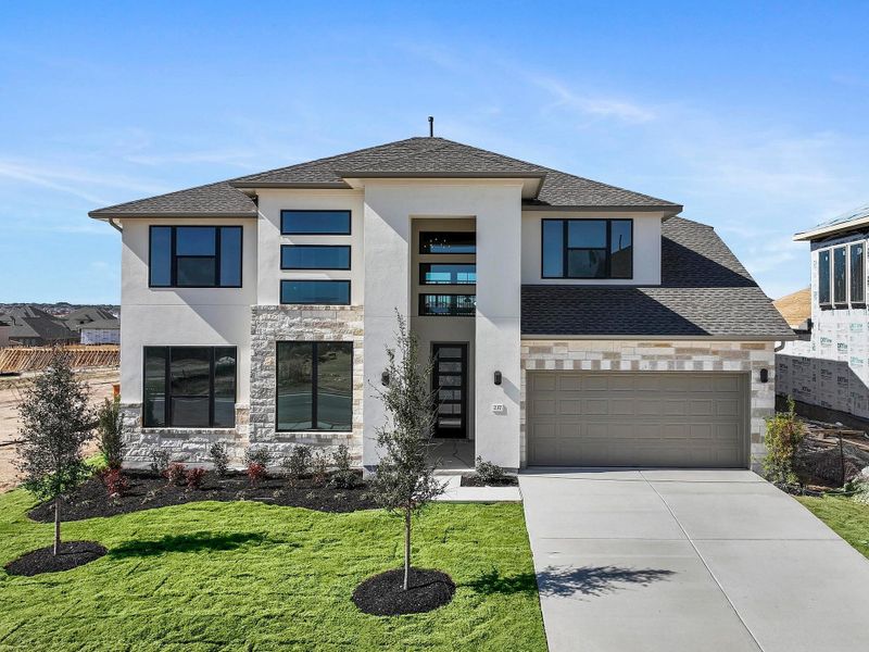 Front exterior of a new home in Lariat, Liberty Hill, TX, highlighting curb appeal (Image 2). Front exterior of a new home in Lariat, Liberty Hill, TX, highlighting curb appeal (Image 2).