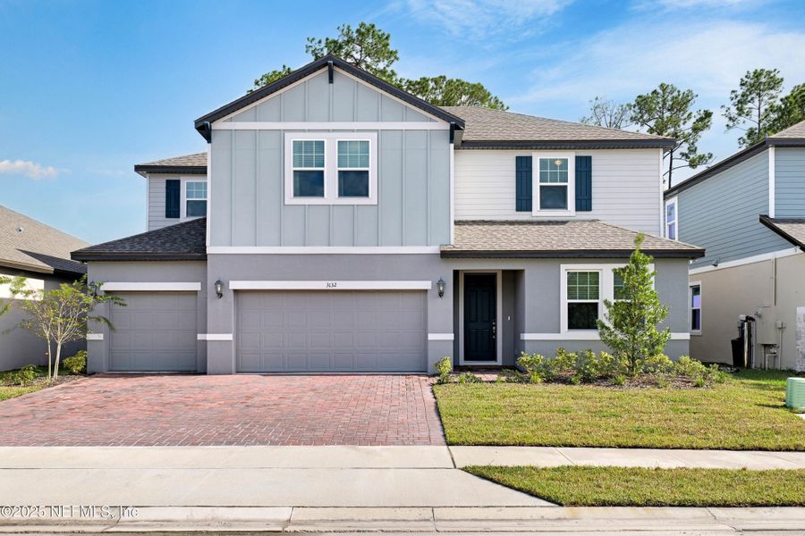 Front exterior of a new home in Legends Preserve - Reserve Series, Daytona Beach, FL, highlighting curb appeal (Image 2).