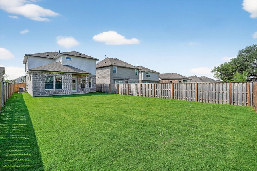 Fenced backyard featuring a patio and a residential view Fenced backyard featuring a patio and a residential view
