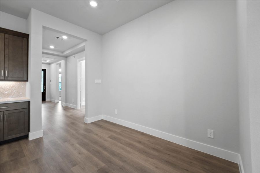 Create lasting memories around the table with family and friends in the breakfast nook! It showcases high ceilings, recessed lighting, and laminate flooring for a warm and welcoming atmosphere.
