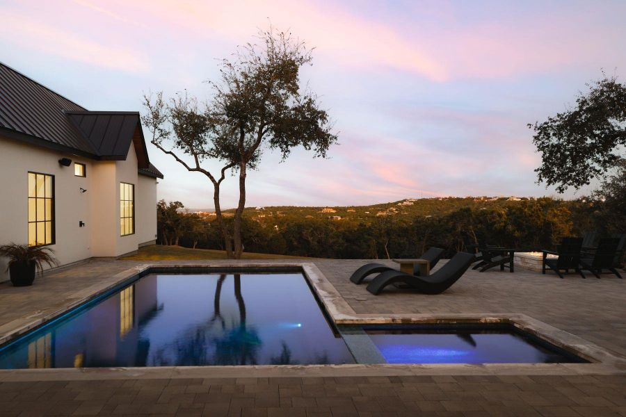 Outdoor pool with a patio and an in-ground hot tub Outdoor pool with a patio and an in-ground hot tub