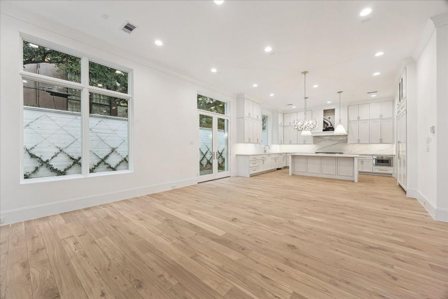 The stunning first floor was designed with relaxation and entertaining in mind! Spacious enough for ample seating surrounding the fireplace, a large dining table, and an island with additional seating that overlooks the living space. Additionally, elevator shaft is off of the living room for future elevator installation, but can be used as large storage closet.