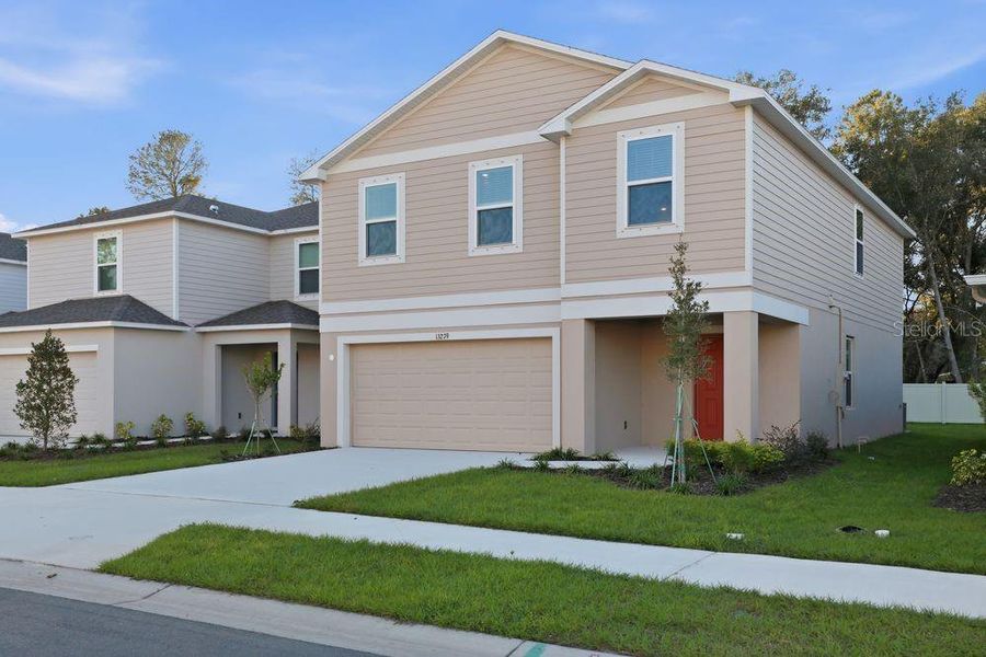 Front exterior of a new home in Palm Wind, Hudson, FL, highlighting curb appeal (Image 24).