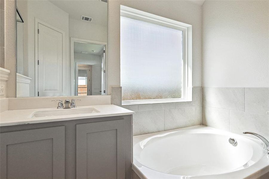 Bathroom with vanity and a bathtub