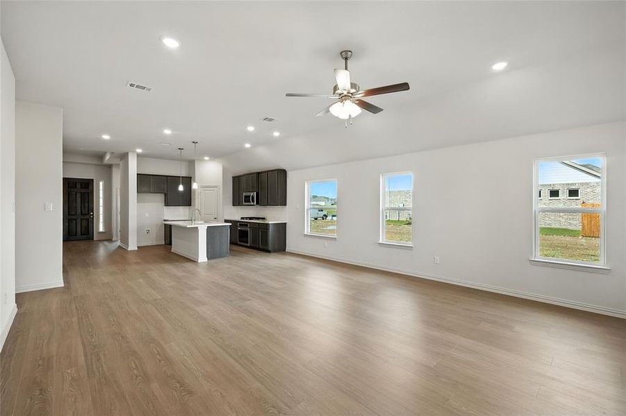 Unfurnished living room with light wood-style flooring, recessed lighting, and ceiling fan Unfurnished living room with light wood-style flooring, recessed lighting, and ceiling fan