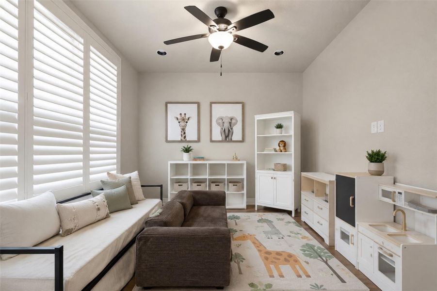 A well-lit play space features elegant window shutters and comfortable seating, ideal for relaxation and recreation. A well-lit play space features elegant window shutters and comfortable seating, ideal for relaxation and recreation.