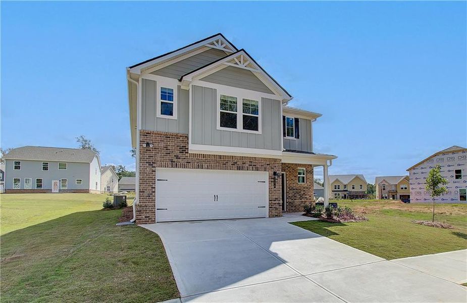 Front exterior of a new home in Enclave at Evergreen, Fairburn, GA, highlighting curb appeal (Image 19). Front exterior of a new home in Enclave at Evergreen, Fairburn, GA, highlighting curb appeal (Image 19).