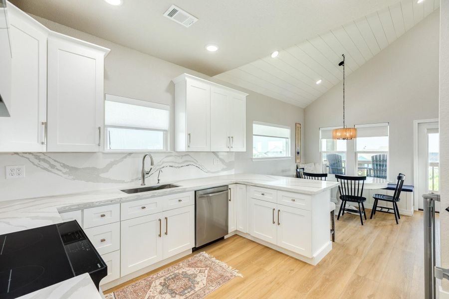 Designed for both function and style, the open kitchen offers generous prep space, abundant storage, and a seamless connection to the dining area.