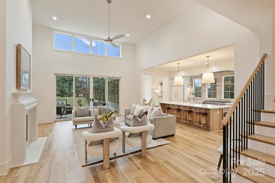 This grand great room boasts 15' tall ceilings and sliding glass doors that seamlessly connect to the covered porch with fireplace.