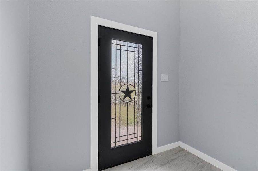 Foyer with baseboards and light marble finish floors