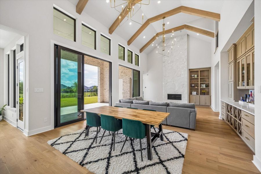 THE MAIN LIVING AREA SHOWCASES SOARING CEILINGS, EXPOSED WOOD BEAMS, AND OVERSIZED SLIDING GLASS DOORS. A FLOOR-TO-CEILING FIREPLACE WALL AND BUILT-IN SHELVING CREATE A STRONG FOCAL POINT. THE MAIN LIVING AREA SHOWCASES SOARING CEILINGS, EXPOSED WOOD BEAMS, AND OVERSIZED SLIDING GLASS DOORS. A FLOOR-TO-CEILING FIREPLACE WALL AND BUILT-IN SHELVING CREATE A STRONG FOCAL POINT.