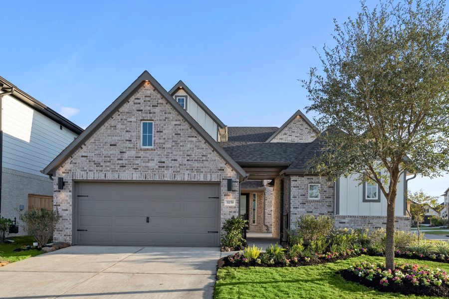 Front exterior of a new home in Cross Creek West 50', Fulshear, TX, highlighting curb appeal (Image 1). Front exterior of a new home in Cross Creek West 50', Fulshear, TX, highlighting curb appeal (Image 1).