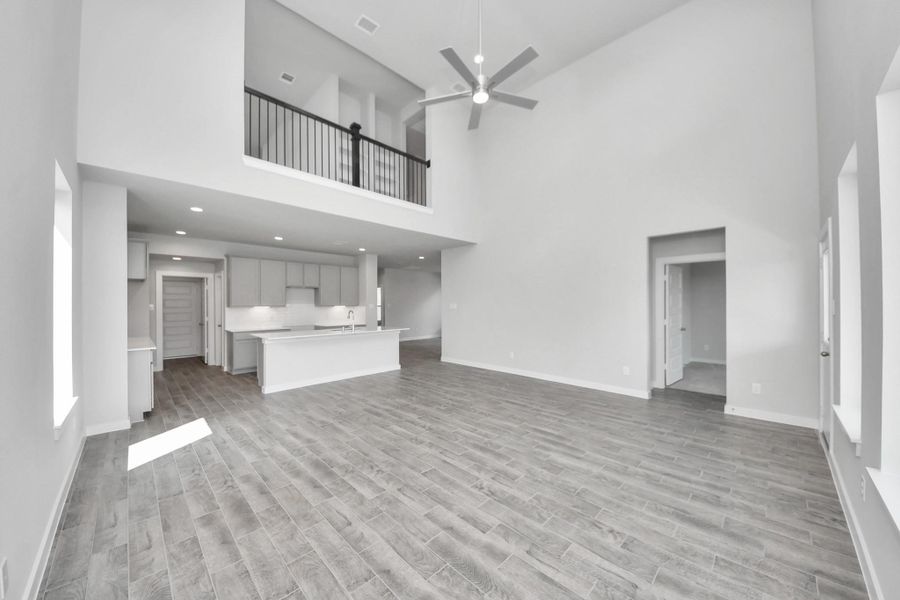 Family room flooded with natural light through the expansive windows. The premium tile flooring adds a touch of luxury to the space, creating the perfect setting for relaxing moments and cherished gatherings with loved ones. Family room flooded with natural light through the expansive windows. The premium tile flooring adds a touch of luxury to the space, creating the perfect setting for relaxing moments and cherished gatherings with loved ones.