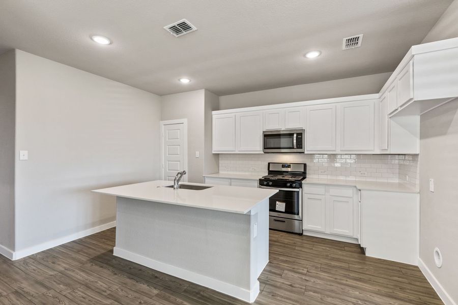 Kitchen in the Willow home plan by Trophy Signature Homes – REPRESENTATIVE PHOTO