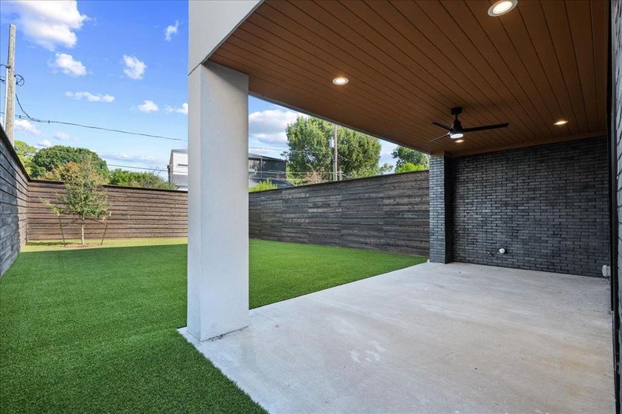 Fenced backyard featuring a patio area and a ceiling fan Fenced backyard featuring a patio area and a ceiling fan