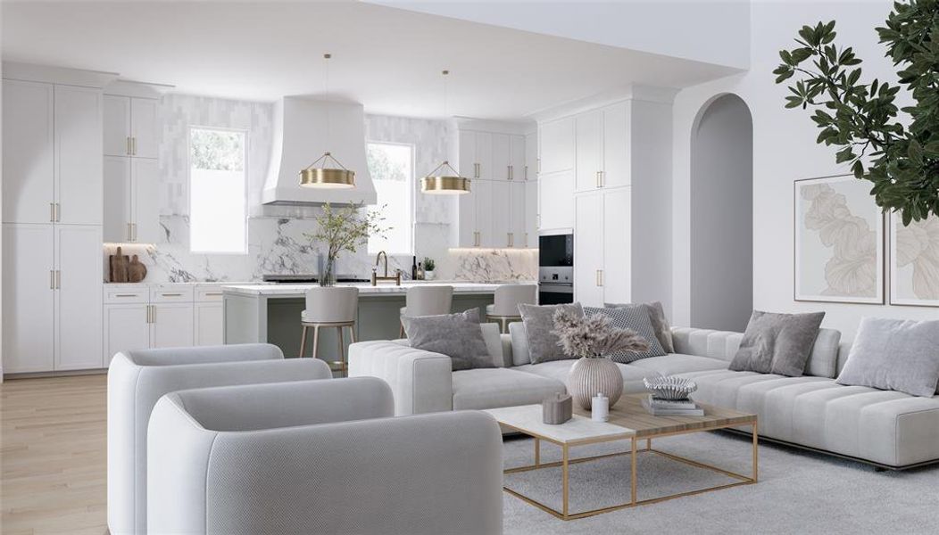 Living area with arched walkways and light wood finished floors