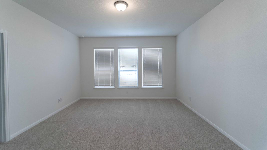 Spare room with light carpet and baseboards