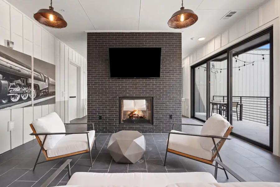 Tiled living area featuring a brick fireplace