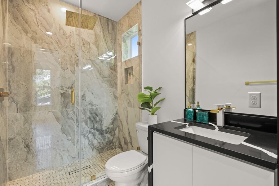 Bathroom with vanity and a marble finish shower Bathroom with vanity and a marble finish shower