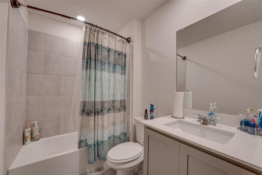 Full bath featuring shower / bath combo and vanity