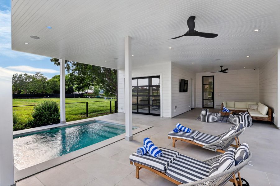An inviting outdoor patio features a refreshing pool, ample lounge space, and convenient direct access to the interior. An inviting outdoor patio features a refreshing pool, ample lounge space, and convenient direct access to the interior.