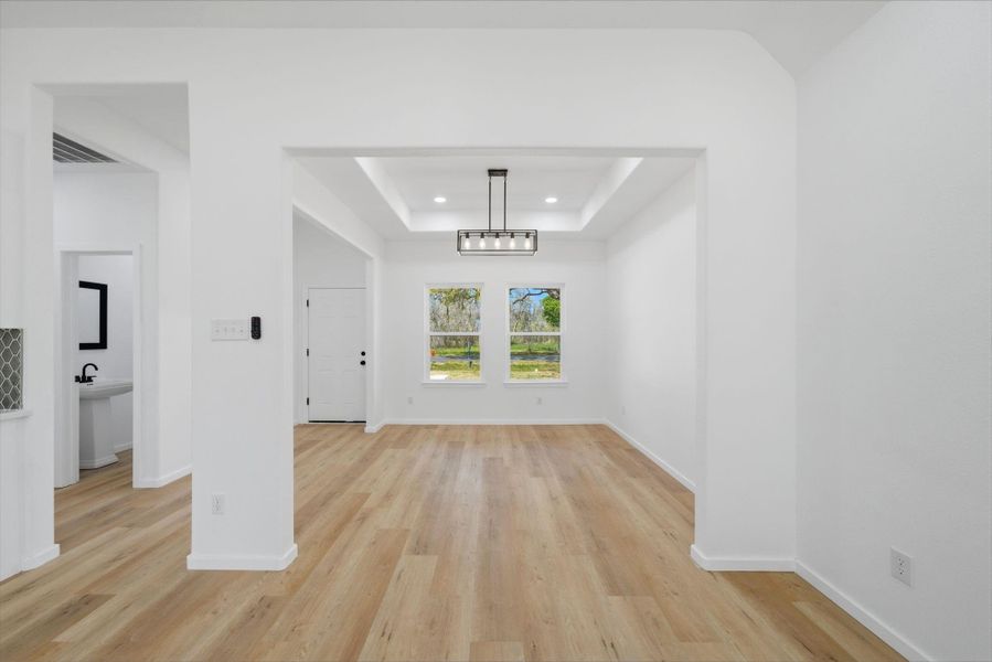 Step into the inviting warmth of this open-concept kitchen and living area, where bright, airy spaces are beautifully highlighted by soft LED lighting. The modern design creates a welcoming atmosphere perfect for family gatherings and entertaining.